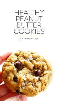 a hand holding a chocolate chip cookie with the title healthy peanut butter cookies gimme some oven