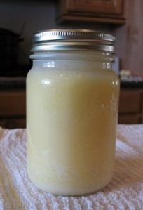 a glass jar filled with liquid sitting on top of a towel