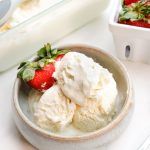 two bowls filled with ice cream and strawberries