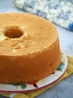 a cake sitting on top of a white and yellow plate next to a blue towel