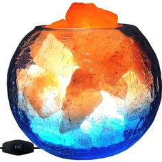 an orange and blue fish bowl is shown with a charger next to it on a white background