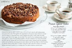 a cake sitting on top of a cooling rack next to two cups and saucers