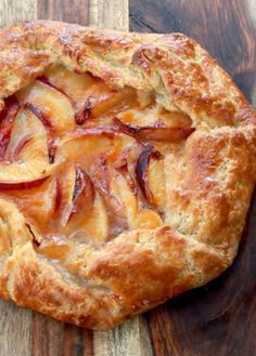 an apple pie on a wooden cutting board