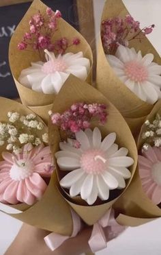 a bunch of flowers that are in some kind of wrapper with pink and white flowers