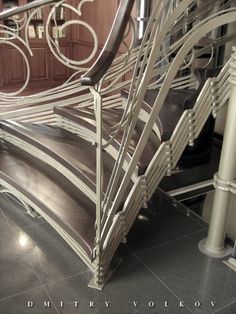 a metal stair case sitting on top of a tiled floor