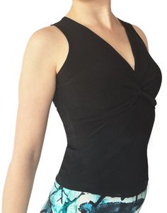 "Classic, v-neck top showcases your fabulous skirts and pants. Bra-friendly, twisted knot detail in front. Soft, silky and stretchy poly/spandex jersey. Item #TL206. Size: -Sizes 4 through 16 Fabric & Care: -Easy care, no-wrinkle poly/spandex -Hand wash cold. Hang dry. Overview: -Great for travel - rolls up small. -Handmade in our studio in Santa Fe, New Mexico USA. Questions about fabric, fit or size? Email me. I am delighted to help. Wholesale orders are available for this item, please con Fitted Ruched Yoga Tops, Summer V-neck Top With Knot Detail, Summer V-neck Twist Front Tops, V-neck Elastane Tops For Yoga, V-neck Elastane Yoga Tops, Yoga V-neck Top In Elastane, Elastane V-neck Yoga Tops, Stretch V-neck Top With Twist Front, Stretch V-neck Twist Front Top