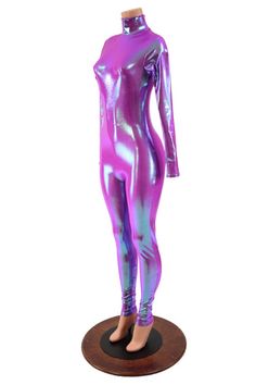 This holographic catsuit is made from our Plumeria four way stretch spandex.  The color shift from deep orchid to icy blue is mesmerizing!  This suit has long sleeves, a turtleneck, and a back zipper.Womens Sizing (See below for instructions on where measurements should be taken)XXS: Bust 29"-30" / Waist 22"-23" / Hips 30"-32"Extra Small: Bust 31"-32" / Waist 24"-25" / Hips 33"-35"Small: Bust 33"-34" / Waist 26"-28" / Hips 36"-37"Medium: Bust 35"-37" /Waist 28"-31" / Hips 38"-40"Large: Bust 39"- Metallic Shiny High Stretch Unitard, Metallic Stretch Unitard For Night Out, Pink Stretch Unitard For Parties, Metallic Fitted Long Sleeve Bodysuit, Metallic High Stretch Unitard For Party, Pink Fitted Bodysuit For Winter, Fitted Pink Bodysuit For Winter, Stretch Purple Unitard, Stretch Unitard For Winter Party