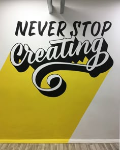 a sign that says never stop creating on the wall