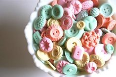 a bowl filled with lots of different colored buttons