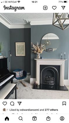 a living room filled with furniture and a piano in front of a mirror on the wall