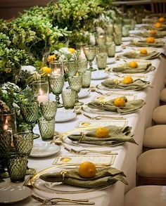 a long table is set with place settings for dinner