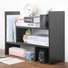 there is a book shelf with many books on it and a clock above the shelves