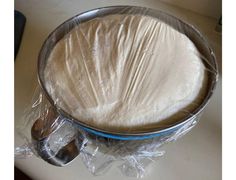 a metal pan sitting on top of a table covered in plastic