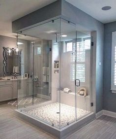 a large bathroom with a walk in shower next to a sink and toilet on top of a hard wood floor