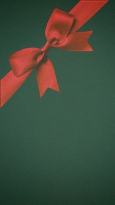 a red bow on top of a green background