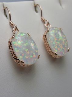 Simulated Opal Earrings Description Edward Design#70 Made to Order These are Edwardian reproduction earrings in sterling silver and rose gold (also available in sterling silver without plating, yellow gold plated, or even 10/14k solid gold) set with stunning simulated rainbow Opal gemstones. Each stunning simulated oval cabochon Opal is 14mm long (9/16th") and 10mm in width (3/8th"). The earrings are 1 and 3/4th inches long. Notice the beautiful swirl and etched filigree of the setting. These lo Engraving Jewelry, Edwardian Art, Order Design, Victorian Vintage, Filigree Earrings, Etsy Wedding, Sterling Silver Filigree, Wedding Bridesmaid, Fashion Ring