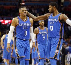 two basketball players standing next to each other