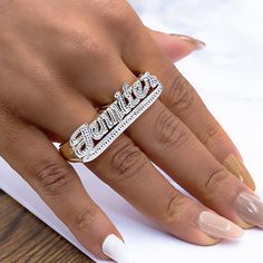 This fabulous two-finger name ring blends the retro with the amazing. It looks great regardless if you wear it on its own or decide to use your name ring stacked with other rings as well. It's a great option for men or women who love the two-finger name ring look. This two-finger name ring features a tail at the bottom of the name with a beading finish. The character limit is 12