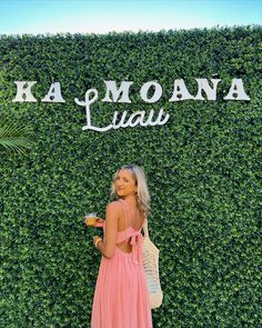 a woman standing in front of a green wall