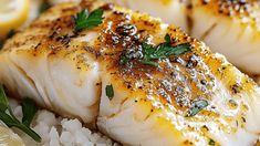 some fish and rice on a plate with lemons