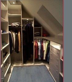 an attic bedroom with closets and clothes