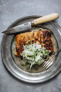 a plate with some food and a knife on it