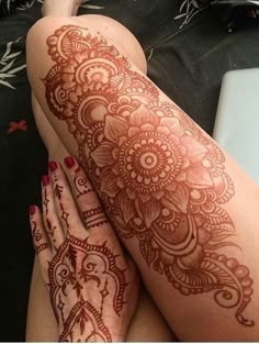 the legs are covered with henna tattoos