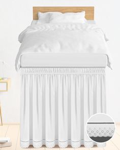 the bed is made with white linens and has a ruffled skirt on it