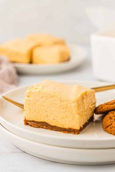 a white plate topped with cookies and a piece of cheesecake