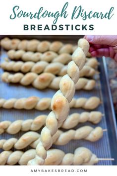 some kind of breadsticks that are on a baking sheet with text overlay