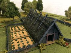 a model house made out of grass and trees