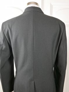 "This military jacket is in near mint condition and is a prime example of exquisite vintage Norwegian military tailoring. The European officer blazer is gunmetal gray, has a notch collar, and closes in the front with two gold buttons. The buttons have an upright crowned lion on them, as do the pockets on the four pockets on the front of the jacket (2 flap pockets at hip level and two on the chest). The NATO jacket has a center back vent that allow complete ease of movement. The jacket is fully l Gray Double-breasted Formal Blazer, Uniform Style Fitted Business Blazer, Fitted Uniform Business Blazer, Fitted Business Uniform Blazer, Military Style Business Blazer For Winter, Winter Military Style Business Blazer, Fitted Military Blazer With Lapel Collar, Fitted Military Sport Coat For Work, Fitted Military Style Sport Coat For Workwear