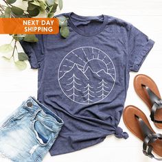 Vacation Shirt, Camping Shirts, Mountain T shirt, Hiker Shirt, Nature Lover Shirt, Adventure T shirt, Family Camping Shirt, Camping Gift BLACK TEXT is used for Yellow, Heather Peach, White, Light Gray Heather, Mint, Pink Shirts. Other colored shirts have white text. F I T ∙ & ∙ S I Z I N G : -->Women's sizes are narrower than the waist. -->Sleeves are rolled up in some product pictures. They do not come rolled up on delivery. T I M E ∙ T O ∙ D E L I V E R Y : -->Processing and production time is Cotton Graphic Print Tops For Outdoor Activities, Blue Outdoor Tops With Screen Print, Cotton Graphic Tee For Outdoor, Blue Screen Printed Tops For Outdoor Activities, Graphic Print Cotton Top For Outdoor Activities, Blue Screen Print Tops For Outdoor Activities, Cotton Screen Print Tops For Outdoor Activities, Blue Tops With Screen Print For Outdoor Activities, Cotton Short Sleeve Shirt For Outdoor Activities