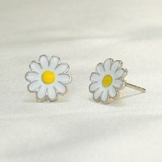 "This stunning 925 sterling silver daisy flower push back stud earrings and necklace set is the perfect gift for any woman who loves sunflowers, nature, or simply beautiful jewelry. The set is made with high-quality sterling silver and features delicate sunflower designs. The earrings feature a single sunflower design with a push back closure. The necklace features a pendant with a larger sunflower design on a delicate chain. The sunflowers are both adorned with sparkling cubic zirconia stones, White Flower Jewelry With Sunflower Design, White Flower-shaped Jewelry With Sunflower Design, White Sunflower Design Flower Jewelry, Sunflower Design Jewelry For Mother's Day, Cute Silver Flower Jewelry, Silver Jewelry With Sunflower Design, Mother's Day Sterling Silver Flower Earrings, Cute Silver Flower Earrings, Sterling Silver Daisy Jewelry