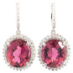 These 18K white gold earrings, weighing a total of 9.24 grams, showcase a dazzling combination of approximately 16 carats of tourmaline and diamonds. Each earring features a checkerboard oval-cut Pink tourmaline, 8.16 carats and 7.78 carats, respectively; both set in a secured prong setting with a diamond halo. The Tourmaline gemstones feature incredible color and luster with excellent color distribution and transparency. Item Details: - Type: Vintage Earring - Metal: 18K White Gold - Weight: 9. Formal Tourmaline Fine Jewelry Earrings, Fine Jewelry Tourmaline Earrings For Formal Occasions, Elegant Oval Tourmaline Earrings, Tourmaline Earrings For Formal Occasions, Vintage Earring, Tourmaline Earrings, White Gold Earrings, Art Deco Diamond, Tourmaline Gemstone