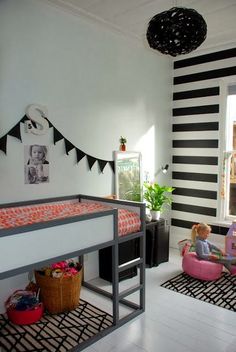 a child's bedroom with black and white striped walls