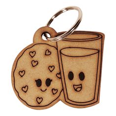 two cookies and a glass of milk with faces drawn on them are keychains