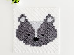 a crocheted square with a black and white bear on it