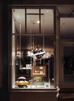 a store window with an assortment of items in the display case and lights above it