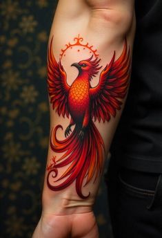 a person with a tattoo on their arm that has a red and orange bird on it