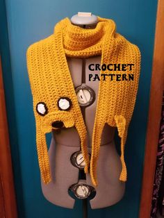 a knitted yellow scarf with buttons on it