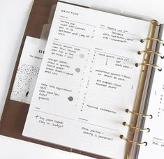 an open planner book sitting on top of a table