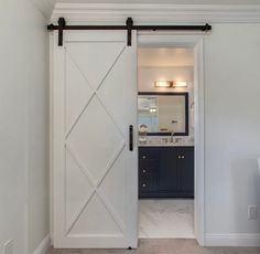 an open door leading to a bathroom with a sink