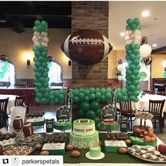 a football themed party with balloons and desserts