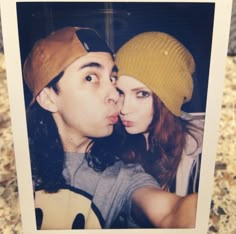 a man and woman taking a selfie in front of a mirror with their noses close to each other