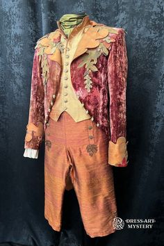 an orange and red suit with gold trimmings on the collar, pants and jacket