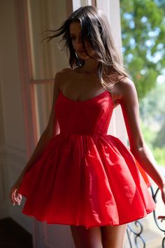 Burst into the night like a cherry-red firework in this strapless poly organdy mini puff dress. The boning and layers of pleated skirt create a structured yet feminine silhouette, while the fiery hue sets the perfect tone for a red hot summer filled with unforgettable moments. Strapless poly organdy mini puff dress with boning Non slip bias elastic at bust Four layers of pleated skirt Lined with cotton at bust To ensure the best fit, measure your across bust and high waist before ordering and st Mini Puff Dress, Elegant Homecoming Dresses, Poofy Dress, Silk Dressing Gown, Tulle Mini Dress, Corset Skirt, Puff Dress, Dream Dresses, Dress Shopping