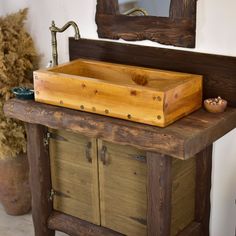 an old wooden sink in a rustic bathroom