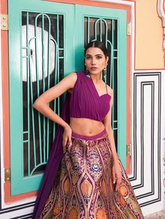 This exquisite Banarasi silk Indo-Western crop top lehenga choli set exudes elegance and charm. The lehenga, crafted from luxurious Banarasi silk, features intricate zari weaving work and is semi-stitched with an inner layer that allows for the attachment of can can, providing a beautiful flair of up to 3 meters. The choli, made from georgette, comes unstitched with a length of 1 meter and can be tailored up to a size of 42 inches. The plain choli complements the elaborate lehenga, making this ensemble perfect for any festive or special occasion.

#BanarasiSilk
#IndoWesternFashion
#CropTopLehenga
#ZariWeaving
#FestiveWear
#EthnicElegance
#DesignerLehenga
#IndianCouture
#WeddingFashion
#SilkLehenga
#TraditionalChic
#LehengaCholi
#FashionInspo
#ElegantOutfits
#CulturalAttire Lehenga Purple, Traditional Chic, Lehenga Crop Top, Crop Top Lehenga, Lehenga Choli Wedding, Party Wear Lehenga Choli, Reception Gown, Bollywood Lehenga, Georgette Blouse