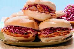 several sandwiches on a plate with coleslaw slaw